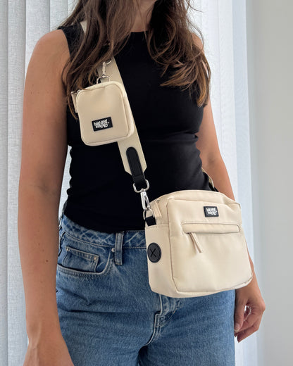Woman wearing a beige baby carrier on a white background